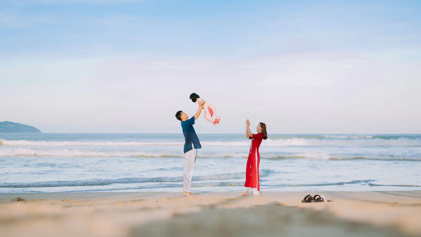 A joyful family bonding on a sunny beach, capturing a beautiful moment of happiness.