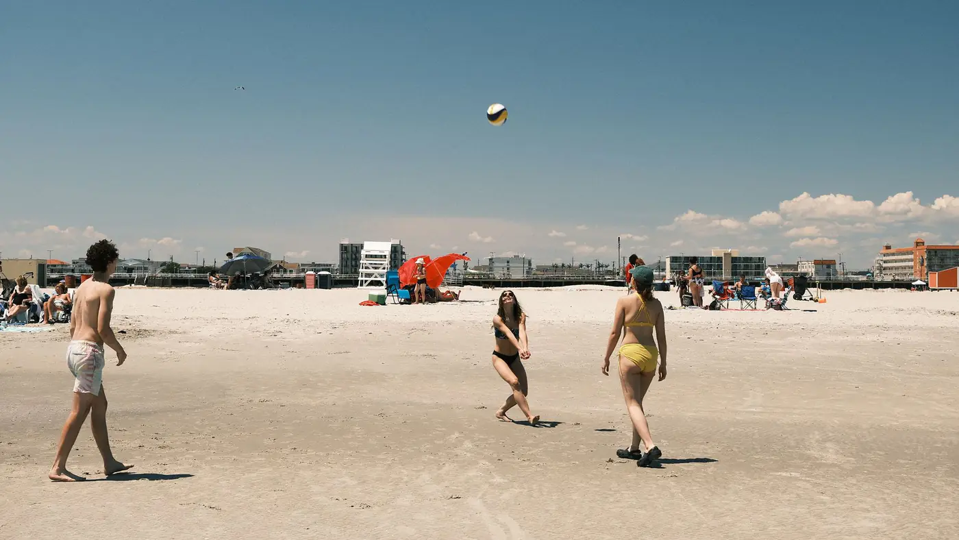 A lively beach volleyball game under a clear sky at Cape May, New Jersey.